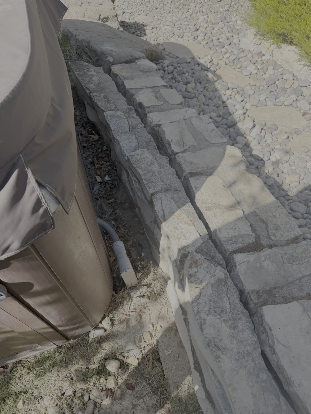 Stone retaining wall detail beside the garden bed at Georgeta’s Lafayette property