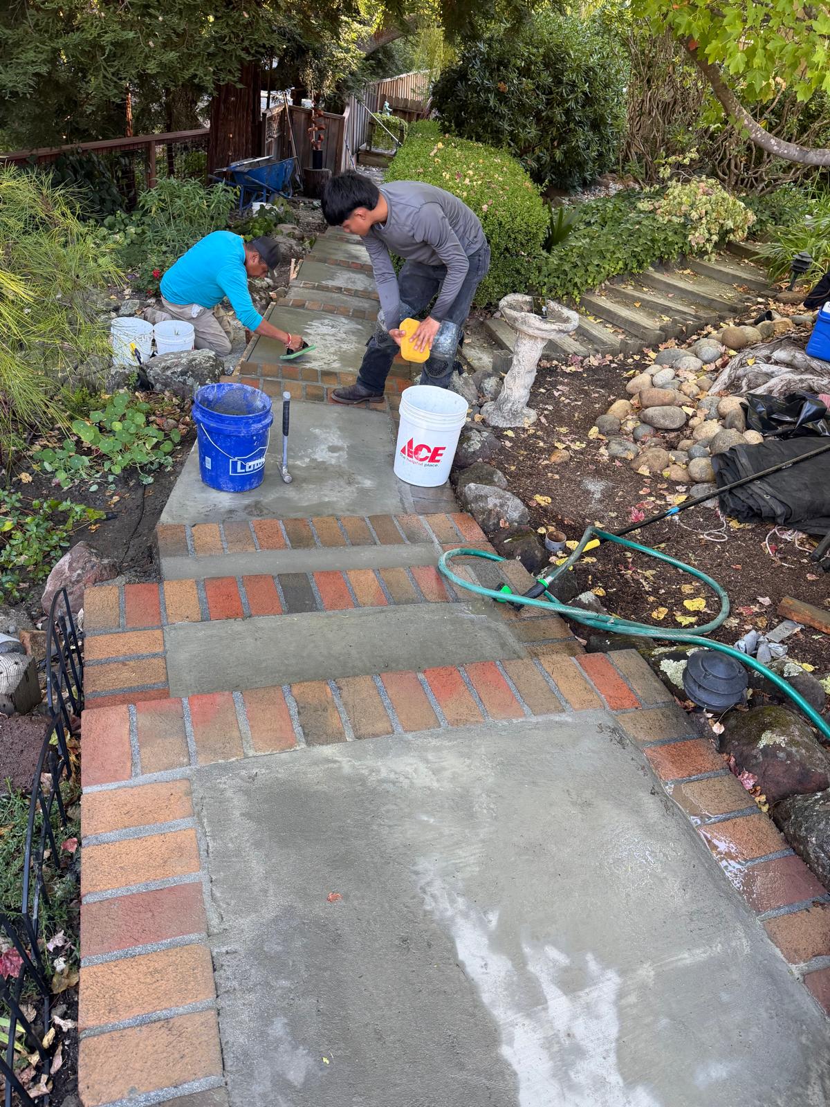 Golden Hills crew finishing fresh concrete treads on the Lafayette brick stairway